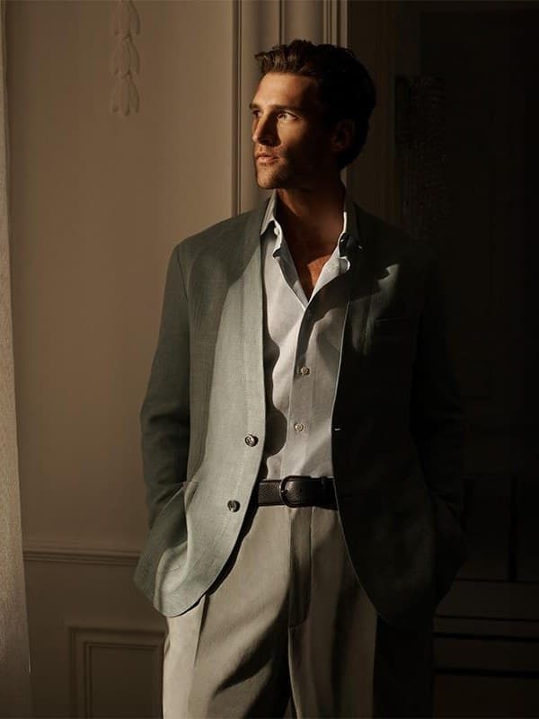 A white shirt worn open-collared, caught in hard window light.